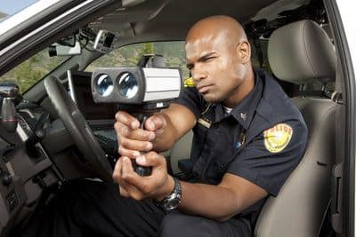 Police officer holding a radar gun